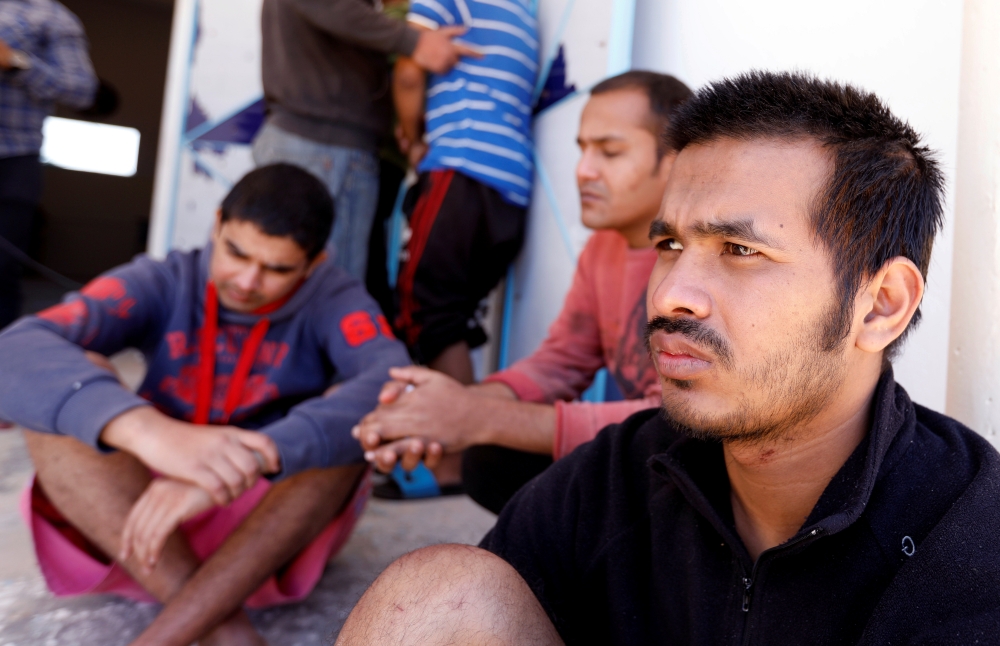 Migrants, who were rescued after their boat capsized in the Mediterranean Sea off the Tunisian Coast after they had left Libya, are seen inside a local Red Cresent chapter in Zarzis, Tunisia May 11, 2019. REUTERS/Zoubei Souissi