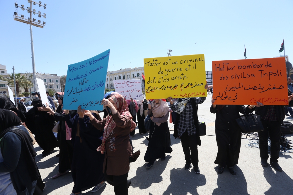 Women carry banners during a funeral ceremony for those died in attacks by Khalifa Haftar forces at the Abu Salim neighborhood's Martyrs Square, Tripoli, Libya, April 17, 2019. Hazem Turkia/ Anadolu Agency