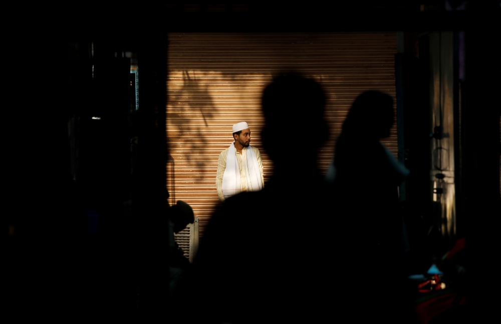 A man stands outside a polling station before casting his vote during the sixth phase of the general election, in the old quarters of Delhi, India, May 12, 2019. Reuters/Anushree Fadnavis 