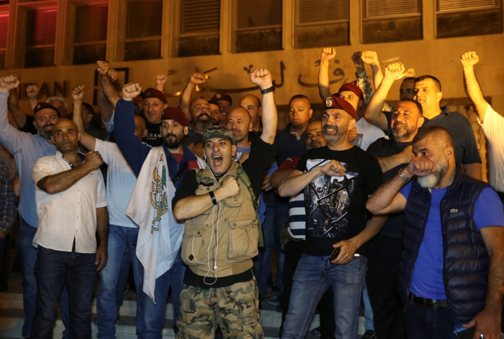 Retired soldiers gesture as they take part in a protest over proposed cuts to the cost of military pensions and benefits in front of the central bank in Beirut, Lebanon May 12, 2019. Reuters/Mohamed Azakir