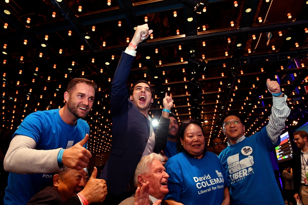 Australia's Liberal Party supporters react during the results count at the Federal Liberal Reception at the Sofitel-Wentworth hotel in Sydney, Australia, May 18, 2019. AAP Image/Mick Tsikas
