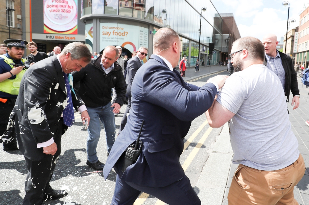 Brexit Party leader Nigel Farage gestures after being hit with a milkshake while arriving for a Brexit Party campaign event in Newcastle, Britain, May 20, 2019. REUTERS/Scott Heppell