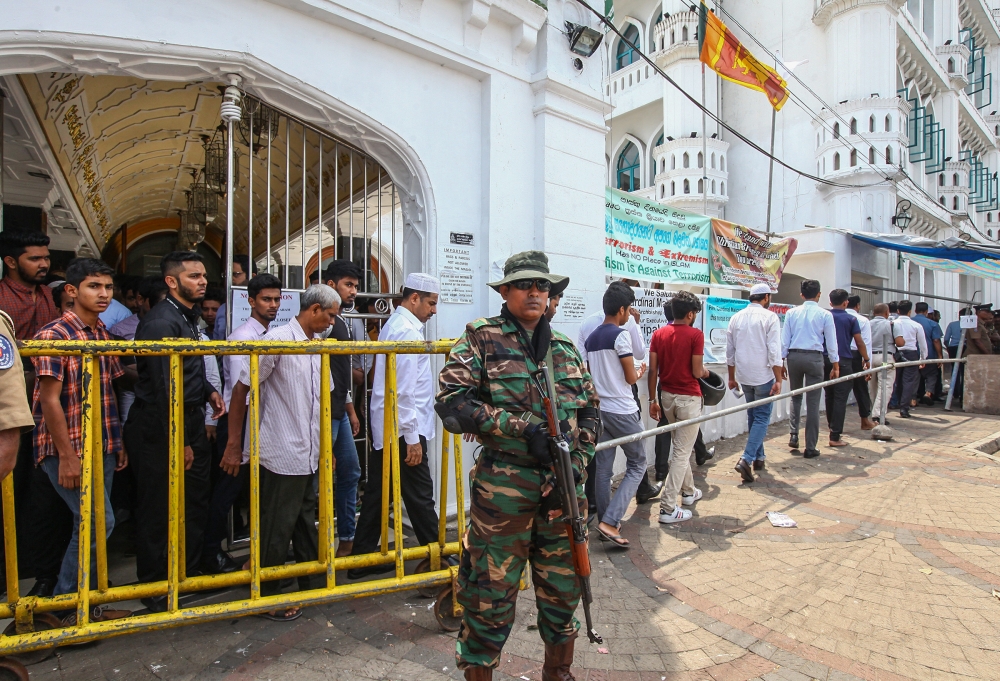 Sri Lankan police officers stand guard outside a Sufi Islamic mosque during Friday Prayer in Colombo, Sri Lanka on May 17 , 2019.  Chamila - Anadolu