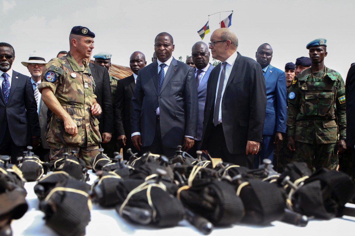 FILE PHOTO: French Defence Minister Jean-Yves Le Drian flanked by President of the Central African Republic Faustin-Archange Touadera looks at military supplies at the Mpoko military base in Bangui on October 31, 2016. AFP