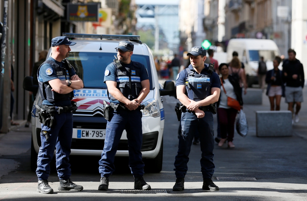 Police patrol the streets during the manhunt of a suspected suitcase bomber in central Lyon, France, May 25, 2019. REUTERS/Emmanuel Foudrot