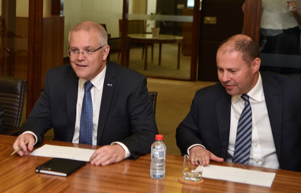 Australian Prime Minister Scott Morrison (L) and Treasurer Josh Frydenberg meet with Reserve Bank Governor Philip Lowe (not pictured) during their meeting at the Reserve Bank in Sydney on May 22, 2019. / AFP / Peter PARKS 