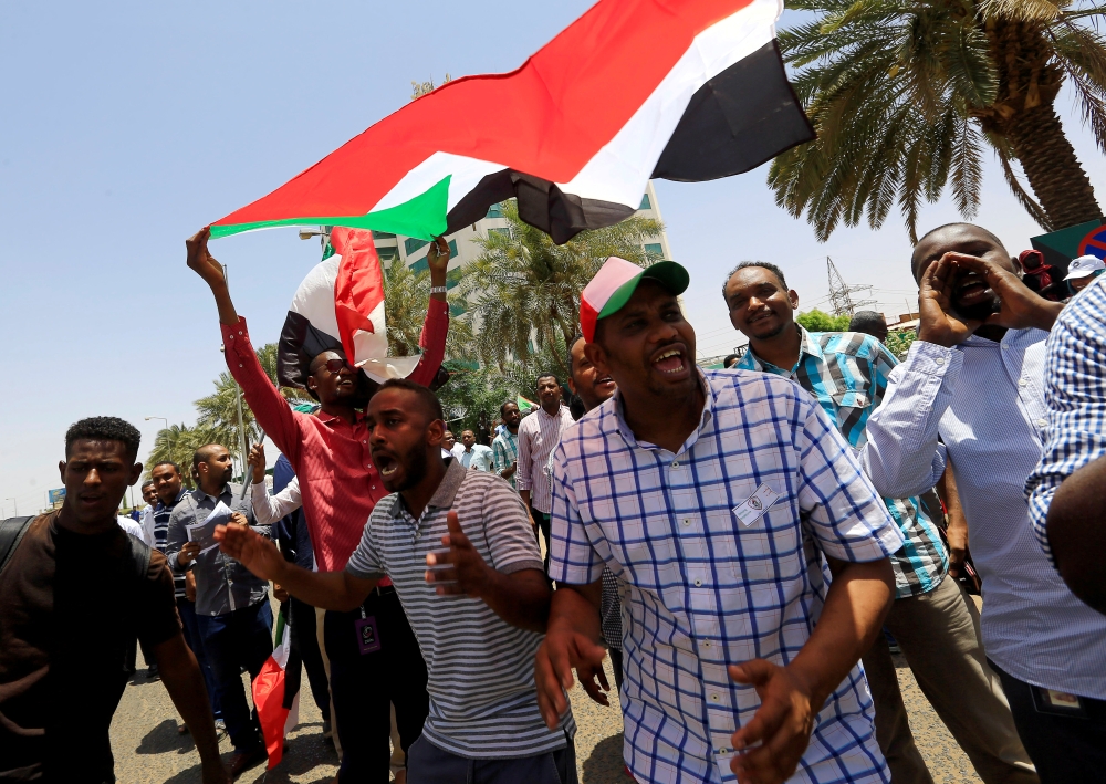 FILE PHOTO: Members of Sudan's alliance of opposition and protest groups chant slogans outside Sudan's Central Bank during the second day of a strike, as tensions mounted with the country's military rulers over the transition to democracy, in Khartoum, Su