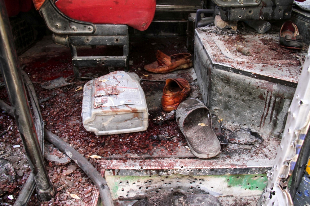 A sandal and shoes belonging to the victims lay inside damaged bus carrying university students in Kabul on June 2, 2019.  AFP