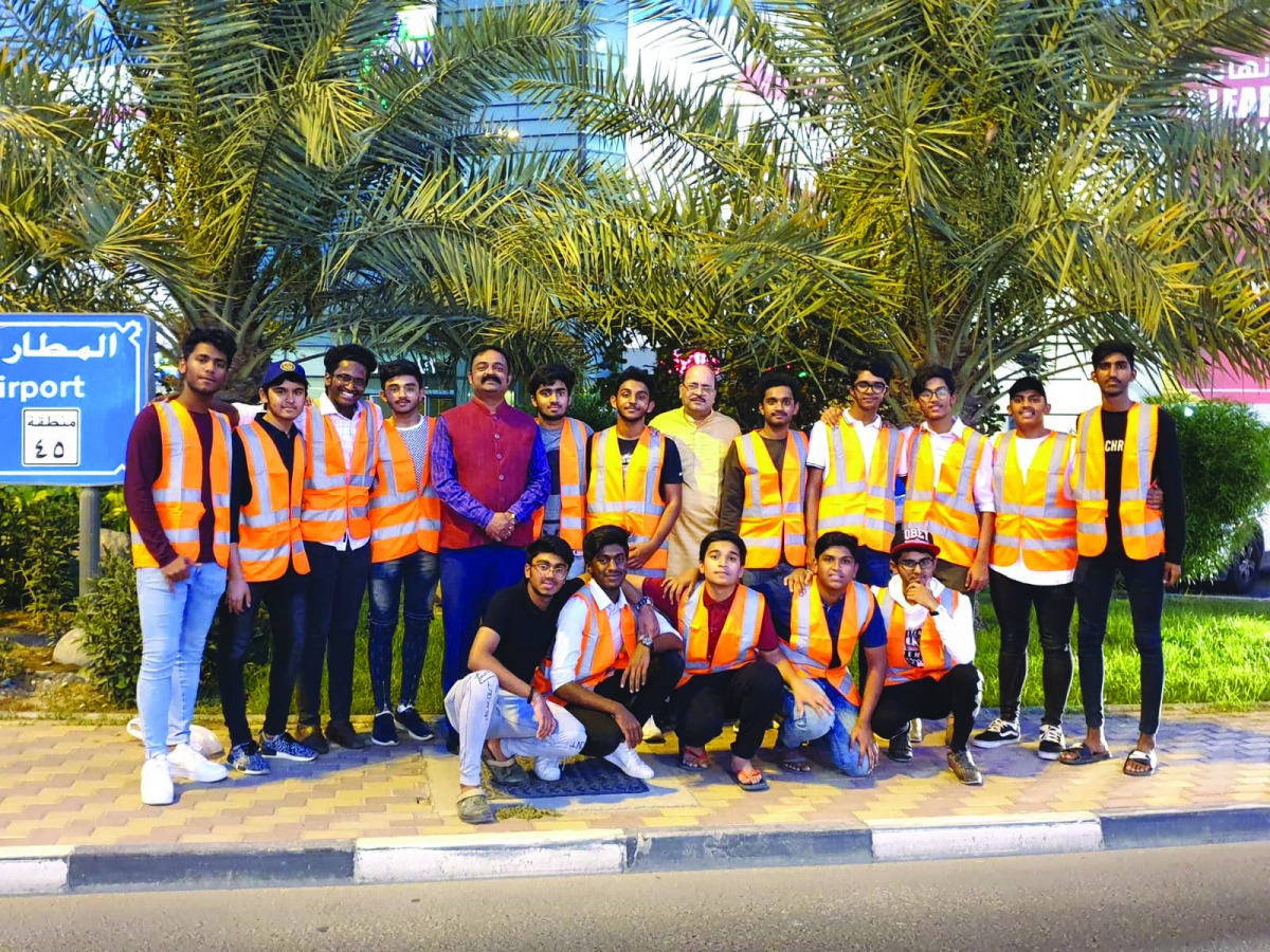 Birla Public School students pose for a group photo while distributing Iftar boxes among commuters.