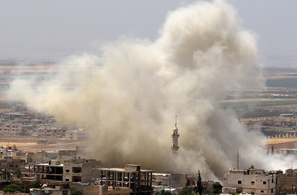 Smoke plumes following reported airstrikes on the town of Khan Sheikhun in the southern countryside of the rebel-held Idlib province on June 3, 2019. / AFP / Anas AL-DYAB
