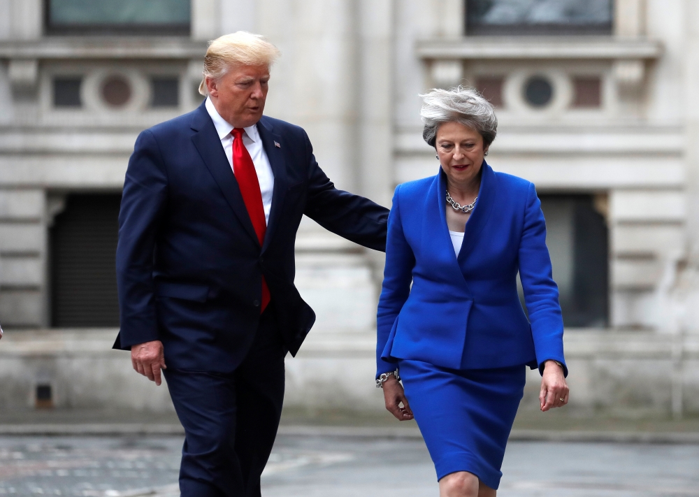 Britain's Prime Minister Theresa May and U.S. President Donald Trump walk through the Quadrangle of the Foreign Office for a joint news conference in central London, Britain June 4, 2019. Frank Augstein/Pool via REUTERS