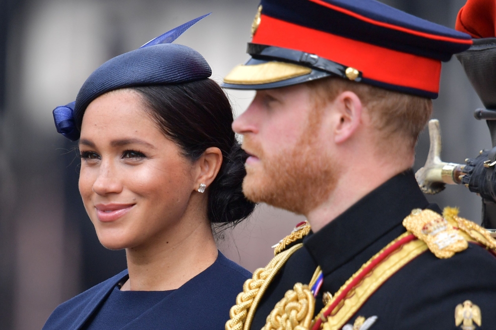 Britain's Meghan, Duchess of Sussex (L) and Britain's Prince Harry, Duke of Sussex (R) make their way in a horse-drawn carriage to Horseguards parade ahead of the Queen's Birthday Parade, 'Trooping the Colour', in London on June 8, 2019. AFP / Daniel Leal