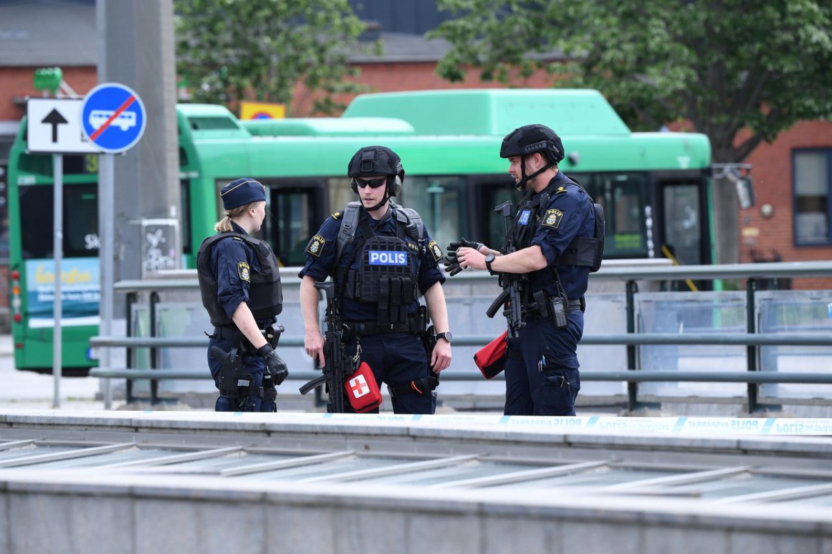 Police members are seen at Malmo central station after shooting a man for 