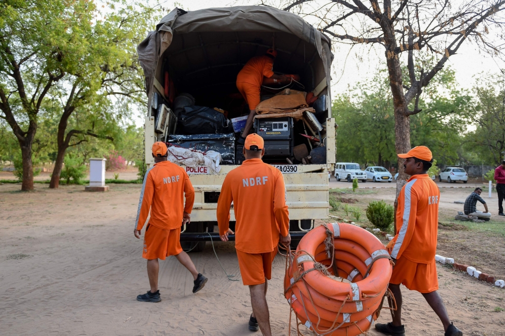 Personnel from India's 6th National Disaster Response Force (NDRF) load life saving material on a truck at a NDRF camp, in Chiloda (also called Naroda), some 40 kms from Ahmedabad on June 11, 2019.  AFP / SAM PANTHAKY