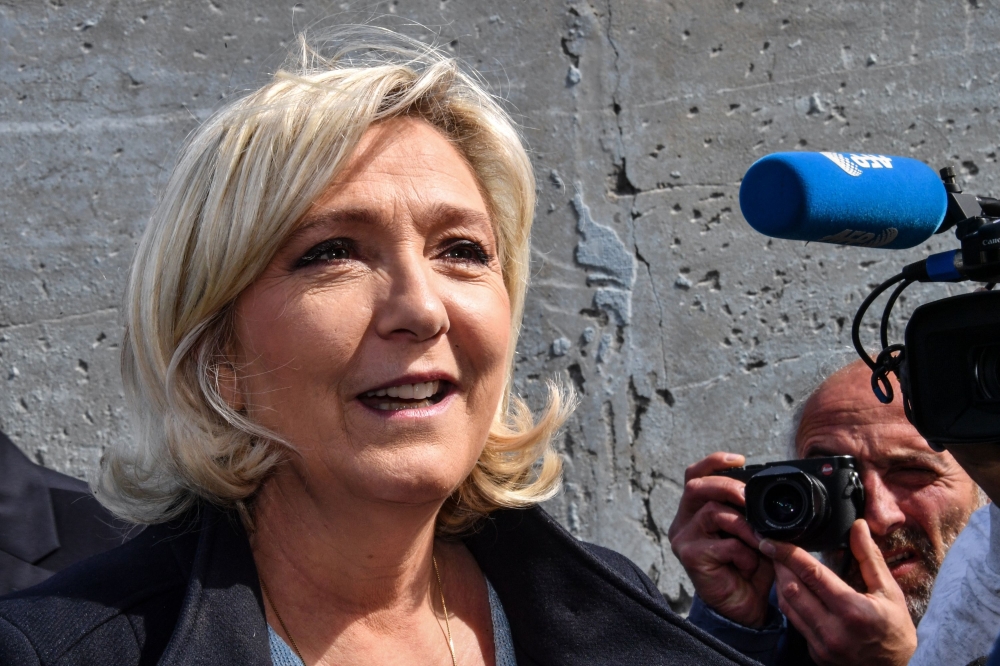 FILE PHOTO: French far-right Rassemblement National (RN) President and member of Parliament Marine Le Pen leaves the polling station after casting her vote for the European Parliament elections in Henin-Beaumont.  AFP / DENIS CHARLET