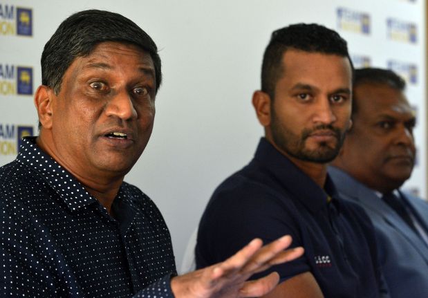 Sri Lanka's Cricket chairman of selector Ashantha de Mel (L) speaks as new (ODI) cricketer captain Dimuth Karunaratne (C) looks on during a press conference in Colombo on April 18, 2019.  AFP / Ishara S Kodikara