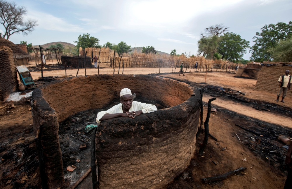 A man is seen inside a burnt house during clashes between nomads and residents in Deleij village, located in Wadi Salih locality, Central Darfur, Sudan June 11, 2019. Reuters