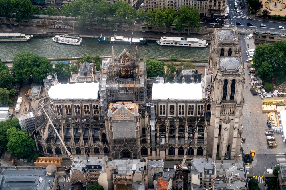 This aerial picture taken on June 12, 2019, in the French capital Paris shows the Notre Dame de Paris cathedral under repair after it was badly damaged by a huge fire on April 15. / AFP / Lionel BONAVENTURE