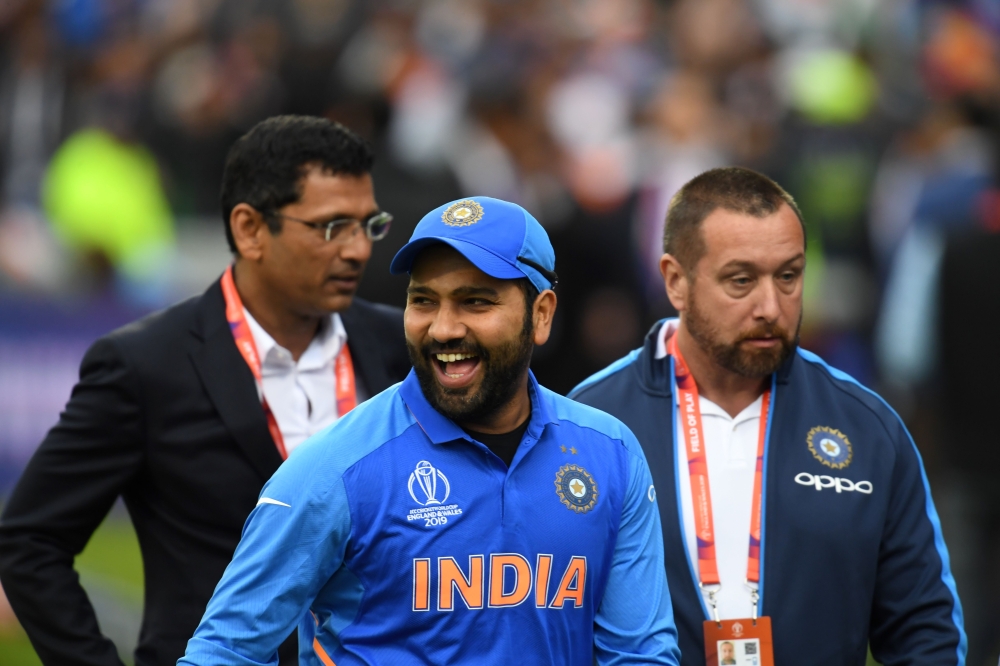India's Rohit Sharma (C) smiles after receiving the man of the match award following victory the 2019 Cricket World Cup group stage match between India and Pakistan at Old Trafford in Manchester, northwest England, on June 16, 2019.  AFP / Dibyangshu Sark