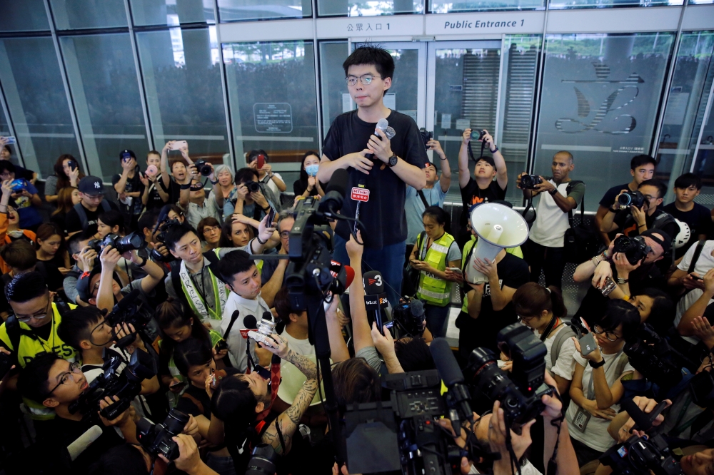 Pro-democracy activist Joshua Wong addresses the crowds outside the Legislative Council during a demonstration demanding Hong Kong's leaders to step down and withdraw the extradition bill, in Hong Kong, China, June 17, 2019. REUTERS/Thomas Peter