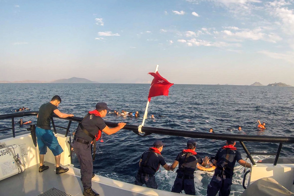 The Turkish coastguard shows illegal migrants being rescued after their boat sank in the Aegean sea, off the coast of southwestern Turkey.