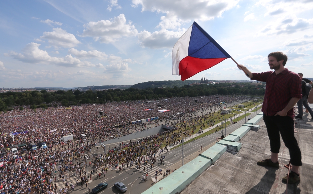 A demonstrator waves a Czech Republic flag during a protest rally demanding resignation of Czech Prime Minister Andrej Babis in Prague, Czech Republic, June 23, 2019. REUTERS/Milan Kammermayer