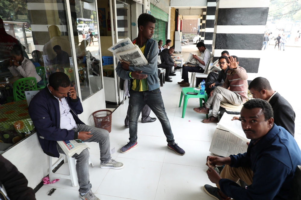 Ethiopians read newspapers in Addis Ababa, Ethiopia June 24, 2019. Reuters/Tiksa Negeri