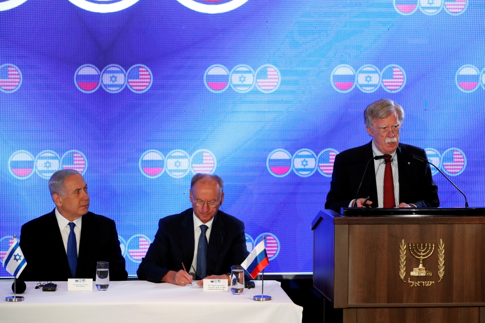 Israeli Prime Minister Benjamin Netanyahu and Nikolai Patrushev, secretary of the Russian Security Council listen as U.S national security adviser John Bolton speaks during opening statements of a trilateral meeting between Bolton, Patrushev and Israeli n