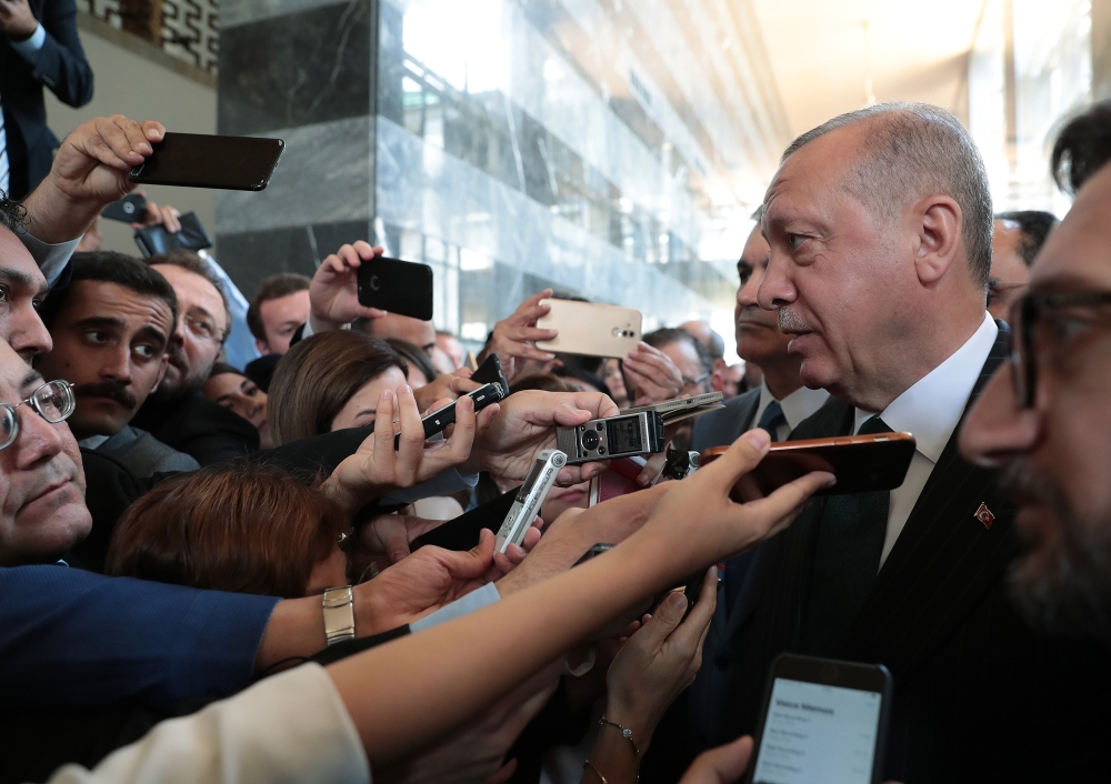 President of Turkey and leader of Turkey's ruling Justice and Development (AK) Party Recep Tayyip Erdogan (2nd R) speaks to media after his party's parliamentary group meeting at the Grand National Assembly of Turkey in Ankara, Turkey on June 25, 2019. 
