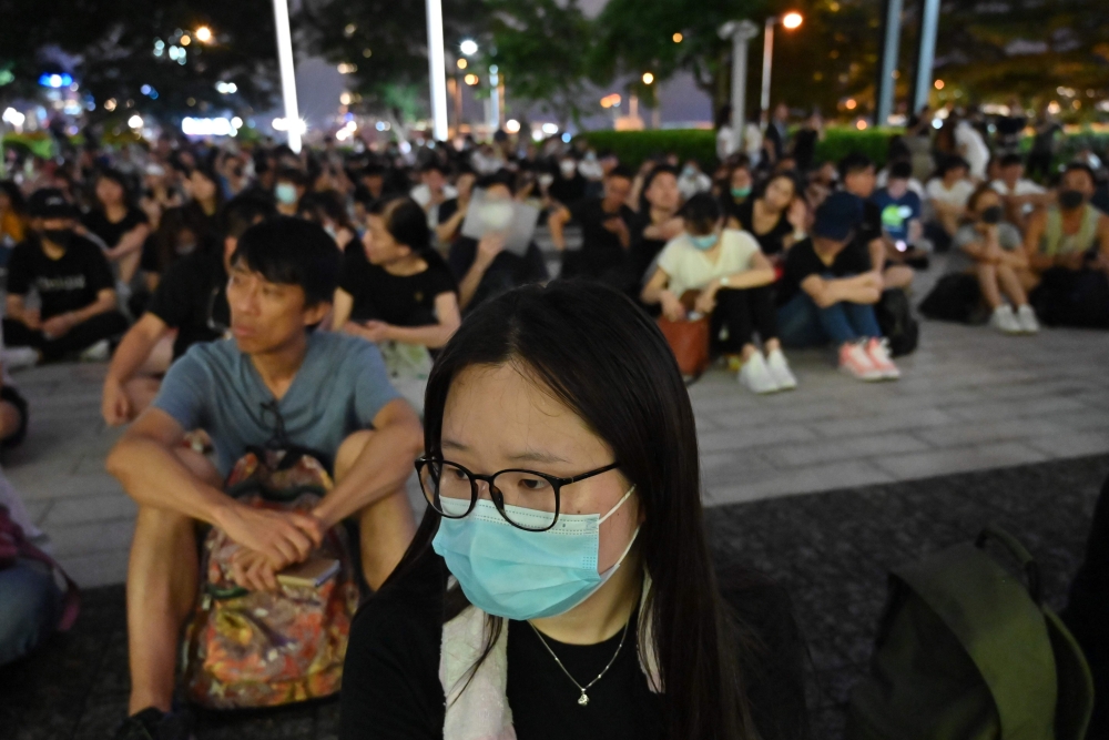 People gather outside of the Legislative Council building to protest against police brutality in Hong Kong on June 23, 2019.  AFP / HECTOR RETAMAL