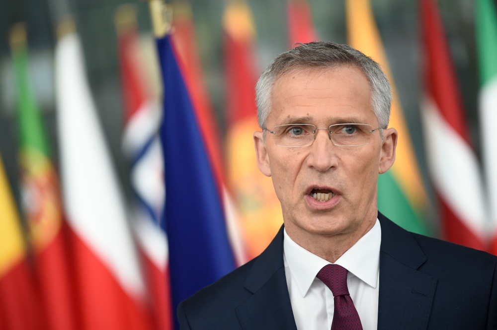 NATO Secretary General Jens Stoltenberg make a statement to the press at the doorstep at the NATO headquarters during a Defence Ministers meeting in Brussels on June 26, 2019. / AFP / JOHN THYS