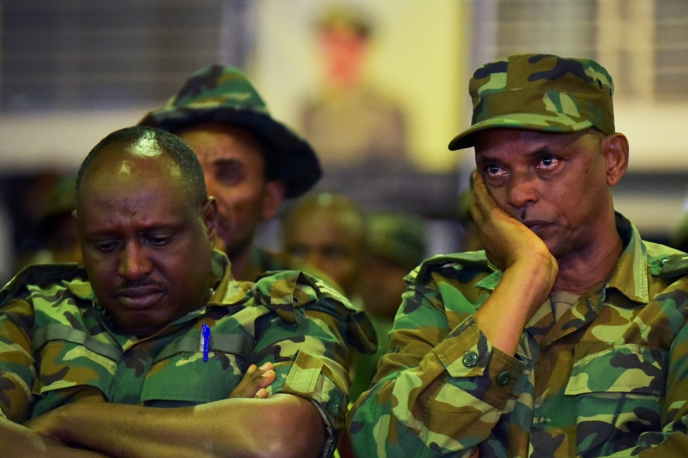 Members of the Ethiopian army mourn during the National funeral service, at the millennium hole in Addis Ababa, of Chief of Staff of the Ethiopian defence forces Seare Mekonnen and of Major-General Geza'e Abera, a retired former senior official in the Eth