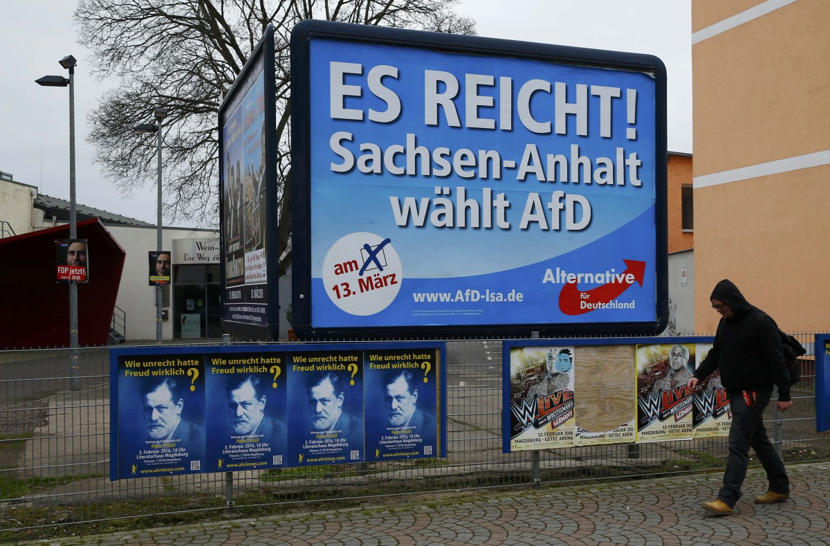 A man walks past an election poster of the right-wing Alternative for Germany AfD party, reading 'Thats enough, Germany' on March 13, 2016. Reuters/Wolfgang Rattay 