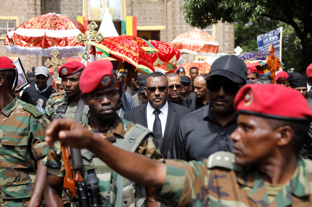 Ethiopia's deputy prime minister Demeke Mekonnen (C) attends the funeral of Amhara president Ambachew Mekonnen and two other officials who where killed in an attack in the town of Bahir Dar, Amhara region, Ethiopia June 26, 2019.  Reuters/Baz Ratner