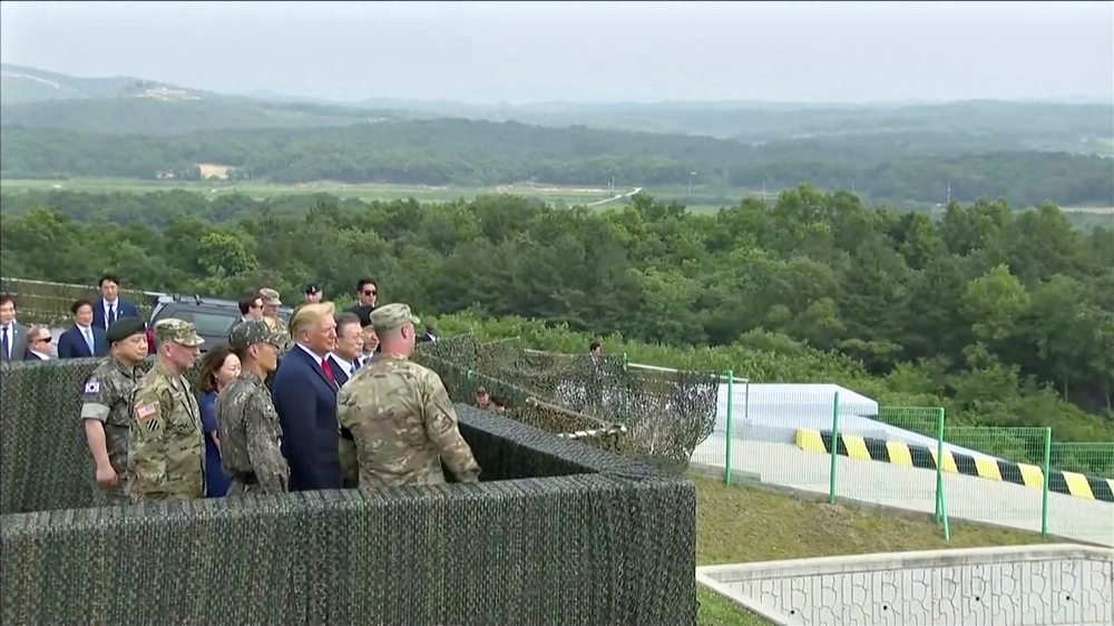 US President Donald Trump and South Korean President Moon Jae-in are seen at the demilitarized zone (DMZ) separating the two Koreas, in Panmunjom, South Korea, in this still image from video taken June 30, 2019. South Korean Pool/via REUTERS TV SOUTH KORE