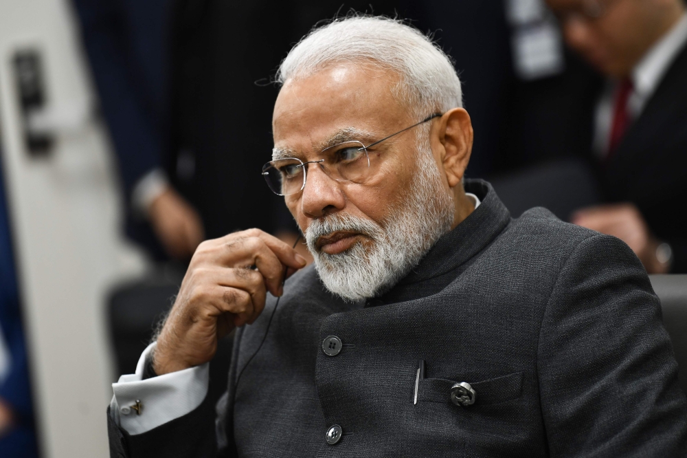 India's Prime Minister Narendra Modi attends a meeting with US President Donald Trump and Japanese Prime Minister Shinzo during the G20 Osaka Summit in Osaka on June 28, 2019. / AFP / Brendan Smialowski