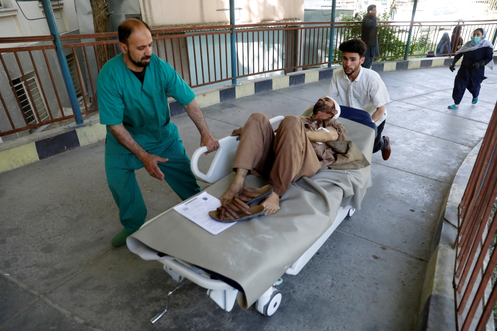 Men transport an injured man to a hospital after a blast in Kabul, Afghanistan July 1, 2019. REUTERS/Mohammad Ismail