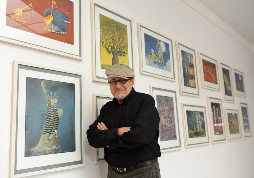  In this file photo taken on July 24, 2012 Argentinian cartoonist Guillermo Mordillo poses in front of his works during a preview of the exhibition 