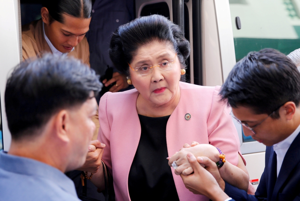 File photo of Aides help former Philippine First Lady Imelda Marcos walk, as she arrives at an anti-corruption court Sandiganbayan, to attend a court hearing in Quezon City, Metro Manila, in Philippines November 16, 2018. REUTERS/Eloisa Lopez