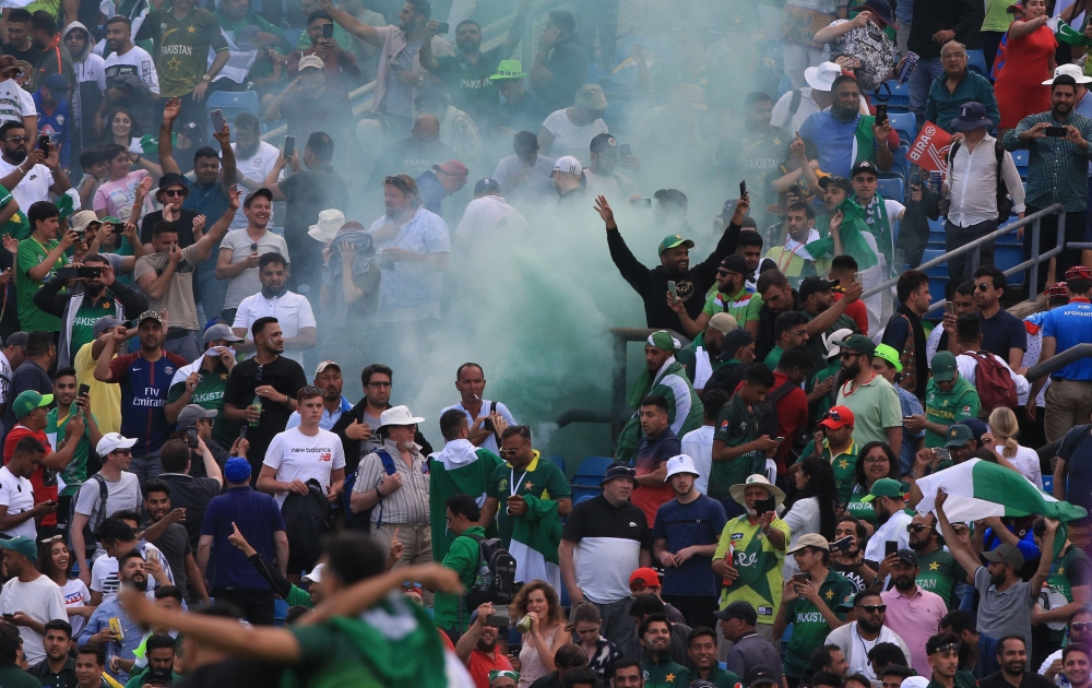Spectators let off flares after the 2019 Cricket World Cup group stage match between Pakistan and Afghanistan at Headingley in Leeds, northern England, on June 29, 2019.  AFP / Lindsey Parnaby 