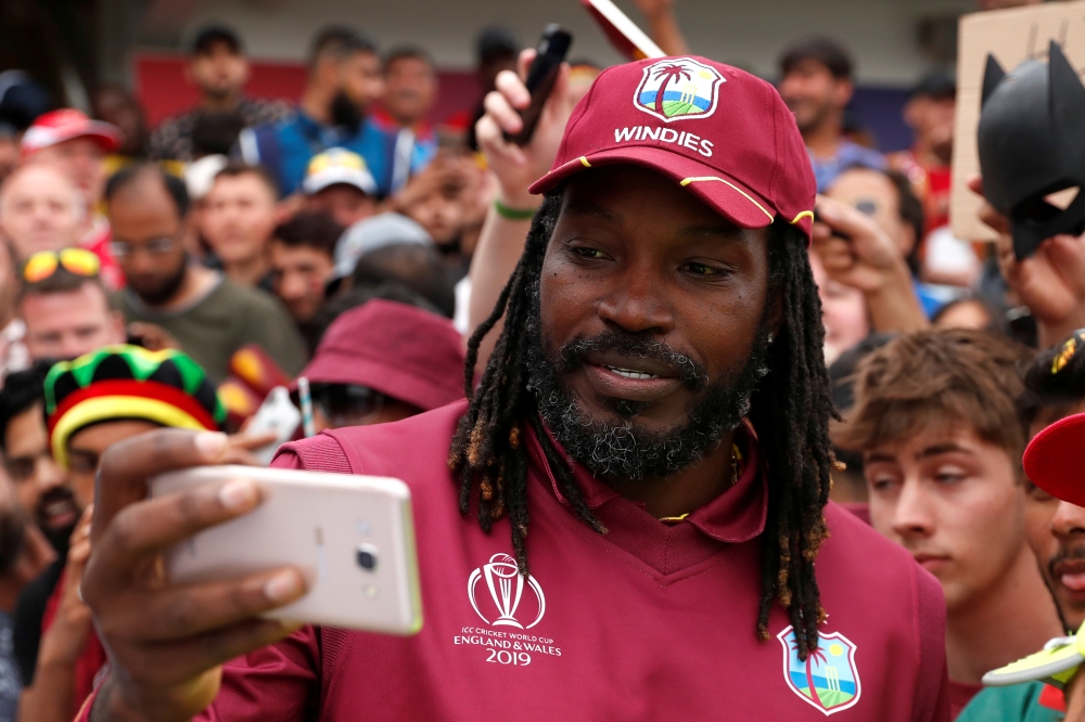 West Indies' Chris Gayle poses for a photo with fans as he celebrates after the match Action Images via Reuters/Lee Smith