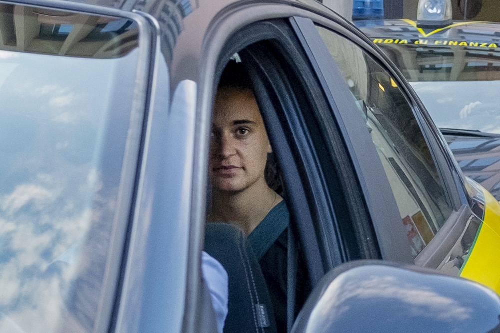 German captain of humanitarian ship Sea-Watch 3 Carola Rackete looks on as she leaves in a car of the Italian Guardia di Finanza law enforcement agency on July 1, 2019 in Agrigento, Sicily (AFP/Giovanni Isolino) 
