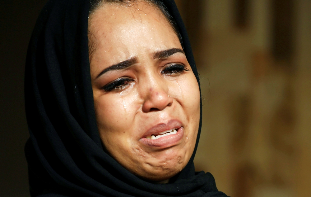 A Sudanese woman reacts during celebration following Sudan's ruling military council and a coalition of opposition and protest groups reached an agreement to share power during a transition period leading to elections, in Khartoum, Sudan July 5, 2019. Reu