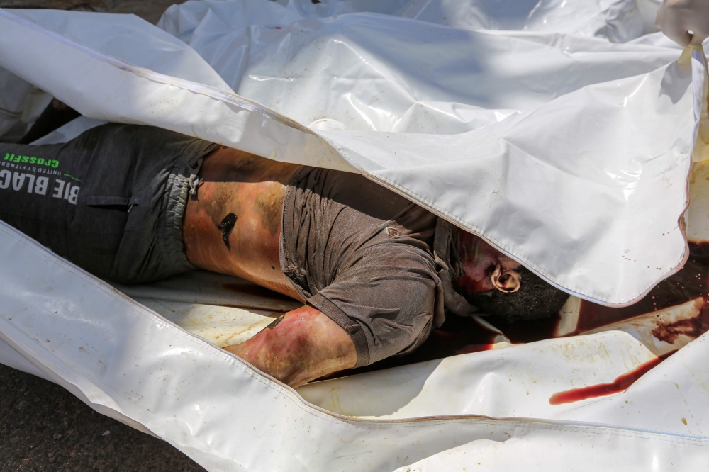 This picture taken on July 6, 2019 in the southern Tunisian coastal town of Zarzis, shows one of the recovered bodies from a migrant boat that capsized off the Tunisian coast while crossing the Mediterranean from Libya to Italy.  AFP / Fathi Nasri