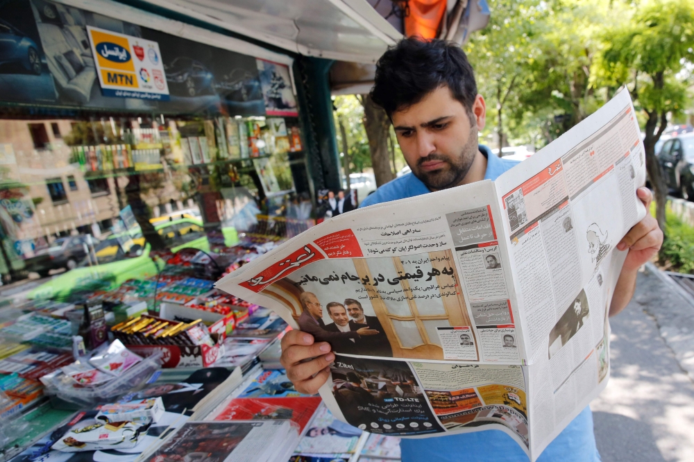 An Iranian man reads a local newspaper in the capital Tehran on July 8, 2019. AFP / Str