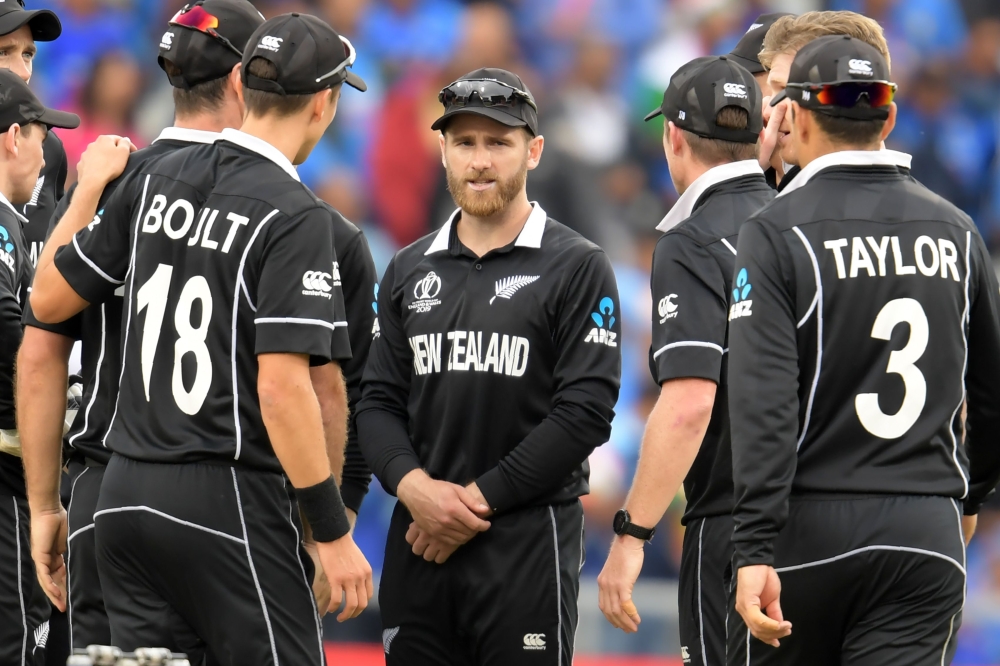 New Zealand's captain Kane Williamson (C) and teammates wait for a review decision during the 2019 Cricket World Cup first semi-final between New Zealand and India at Old Trafford in Manchester, northwest England, on July 10, 2019. New Zealand beat India 