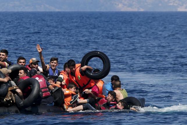 File photo opf drowning migrants being rescued on their way to Greece (Reuters) 