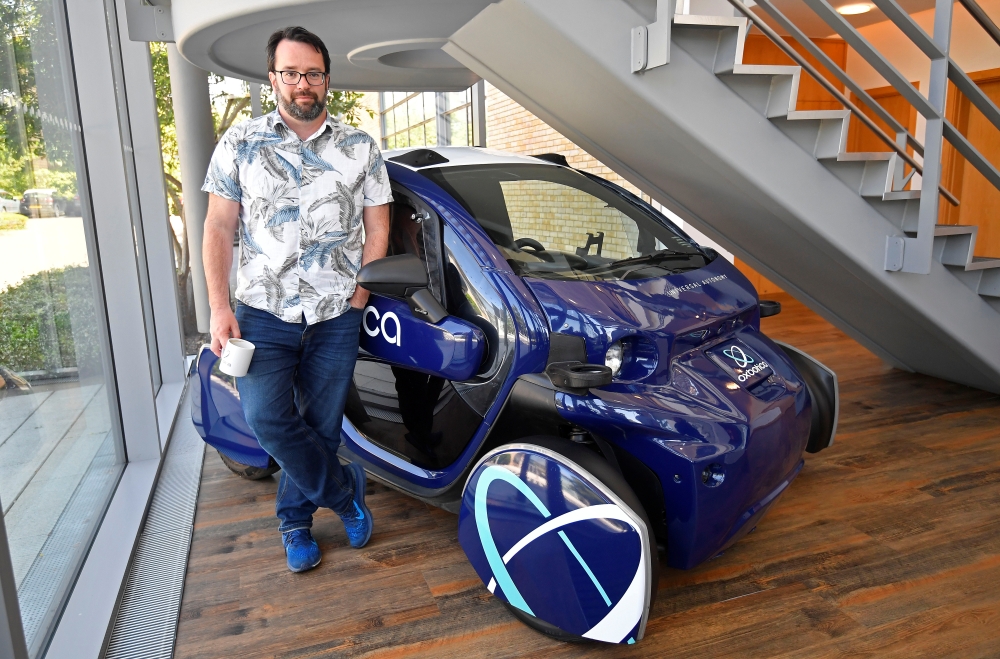 Paul Newman, co-founder of Oxbotica, stands next to an early iteration of an autonomously driven vehicle, at their company headquarters in Oxford, Britain, June 27, 2019. Reuters/Toby Melville