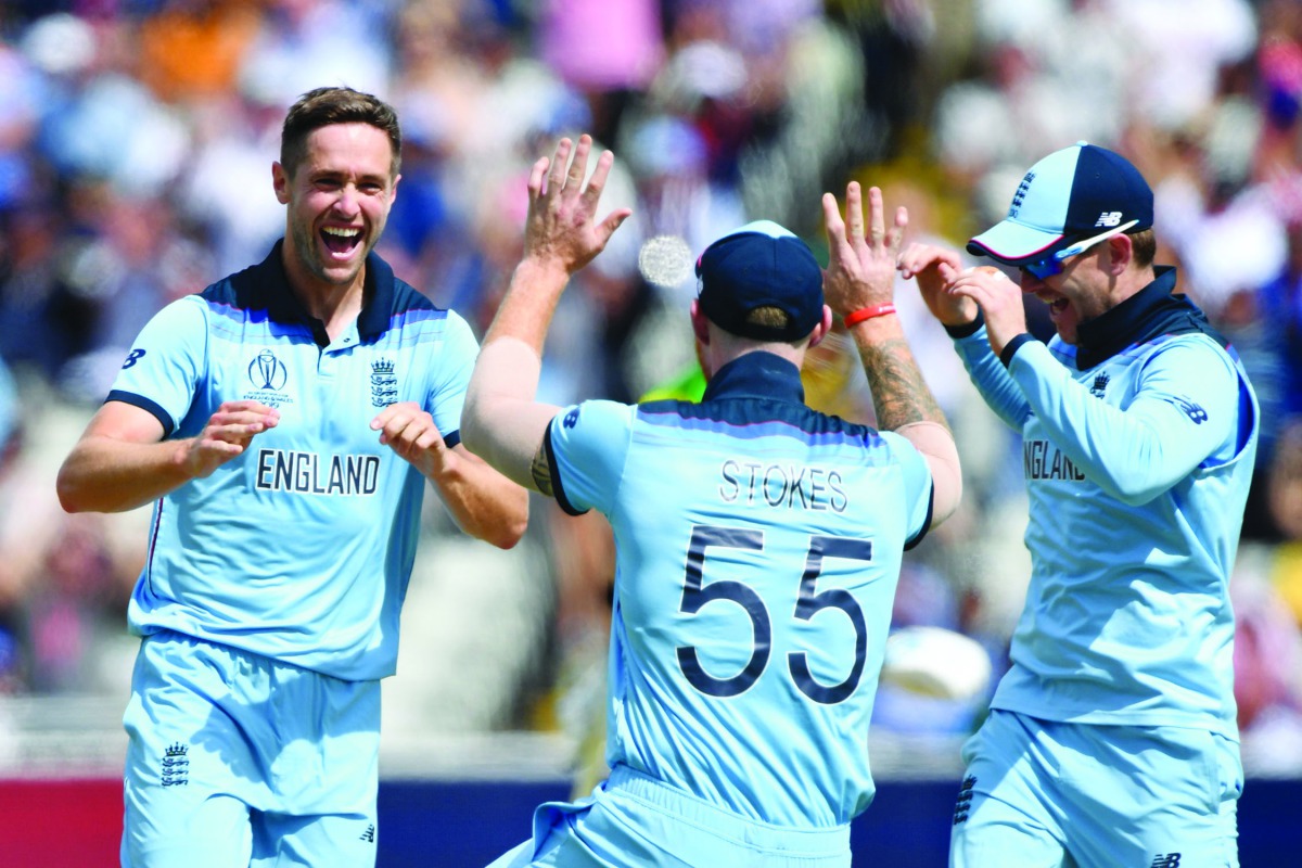 England's Chris Woakes (L) celebrates with England's Ben Stokes after dismissing Australia's Peter Handscomb for four during the 2019 Cricket World Cup second semi-final between England and Australia at Edgbaston in Birmingham, central England, on July 11