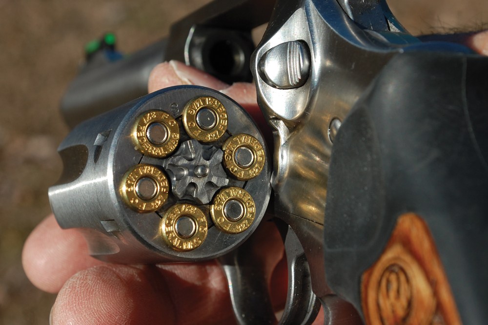 The clip shows the boy being shown how to load bullets into the revolver. The man then hands the gun to his son with the barrel pointed towards the boy. (Photo courtesy: Gun Digest)  